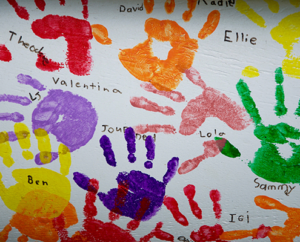 Children's painted handprints with names.