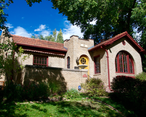 Gray brick home with yard in Congress Park Denver.